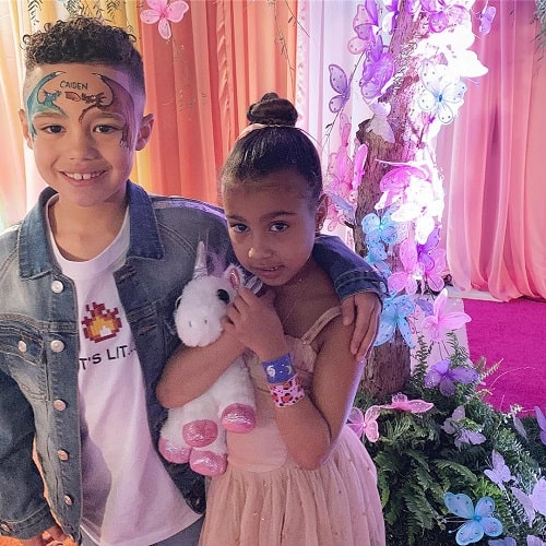 A picture of Caiden Mills with Kanye West's daughter, North West.